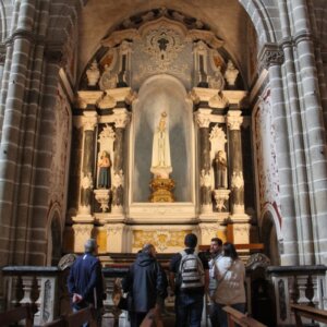 Clients visiting the interior of a historic Portuguese church with guide Rodrigo present.