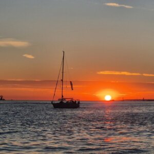 Sailboat river cruise on the Tagus River during sunset in Lisbon.