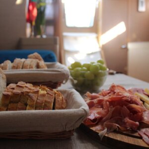 Traditional Portuguese cheeses, cured meats, bread, and grapes served aboard a river cruise in Lisbon.