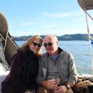 Clients relaxing aboard a river cruise during a private sailing experience on the Tagus River in Lisbon.