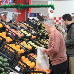 Clients selecting fresh produce at a traditional Portuguese market
