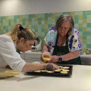 Clients preparing traditional Portuguese custard tarts at a cooking workshop in Lisbon.