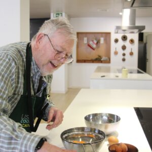 Client participating in a traditional Portuguese cooking workshop in Lisbon.