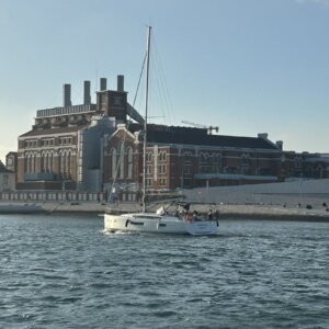 A private boat cruising along Lisbon’s waterfront near MAAT and the Tagus River.