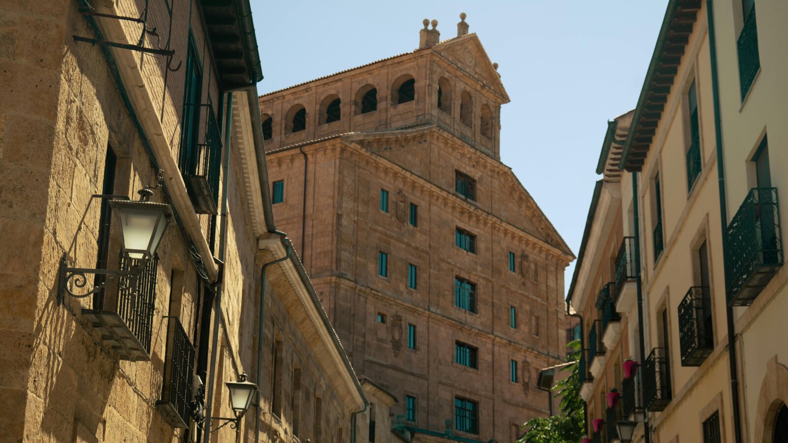 Historic sandstone building with arched windows in the old town of Salamanca, Spain, surrounded by narrow streets and traditional balconies — a highlight on cultural walking tours and Iberian heritage routes.