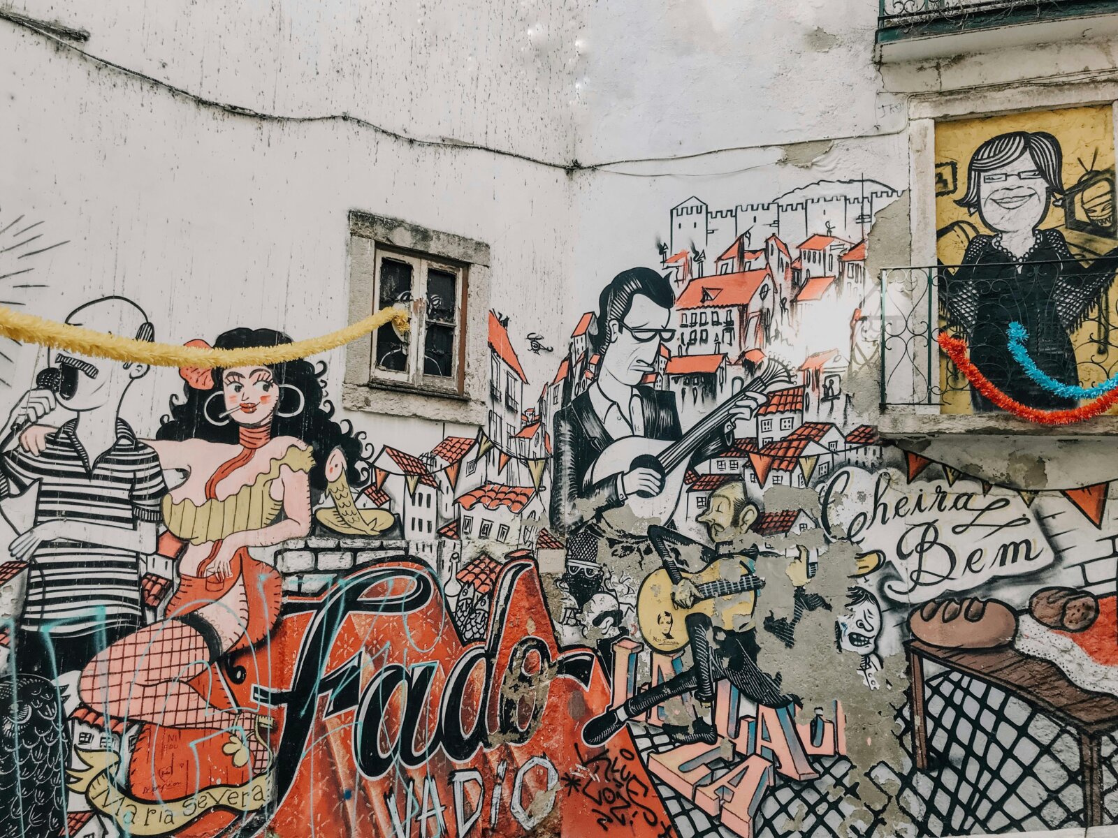 Urban art in the streets of Alfama, Lisbon, with colorful murals paying homage to Fado, Maria Severa, and Lisbon’s tradition, a highlight in the cultural walking tours organized by Premium Tours