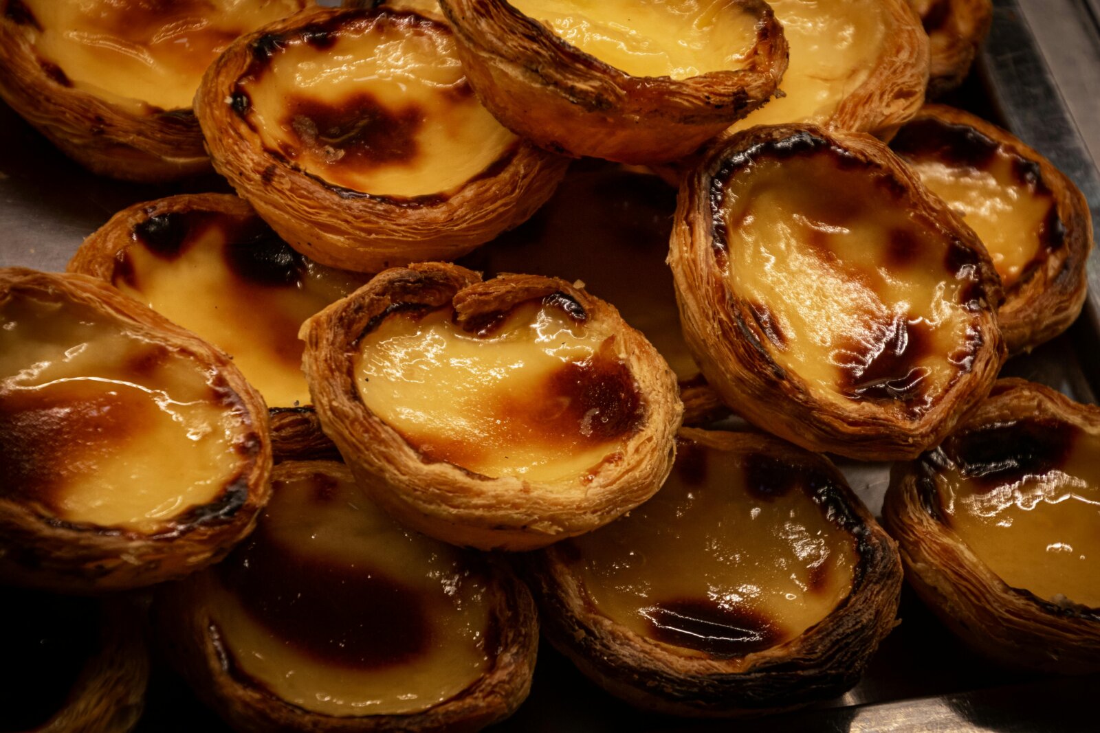Freshly baked pastéis de nata, a typical Portuguese pastry, is a must-try on the Premium Tours food tours in Lisbon and other regions of Portugal. 