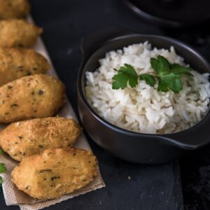 Traditional Portuguese codfish cakes served with white rice and parsley garnish