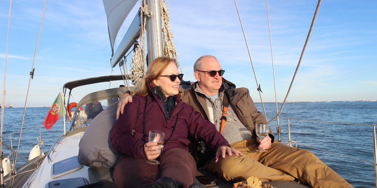 Private Sailing Experience in Portugal Couple enjoying a private sailing tour in Portugal with wine and local delicacies